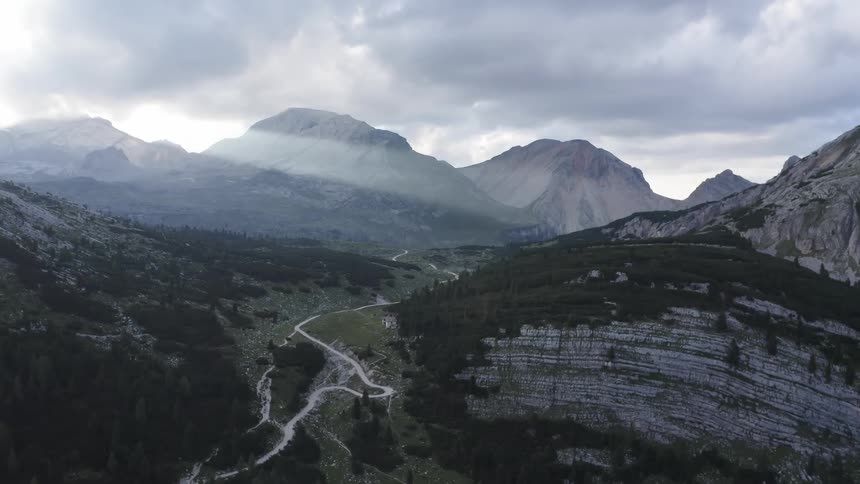 Aerial view of mountain rivers with high mountains against the cloudy sky