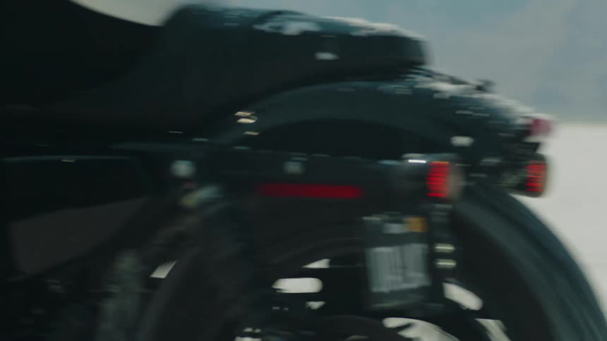 A motorcycle driving in front of a camera