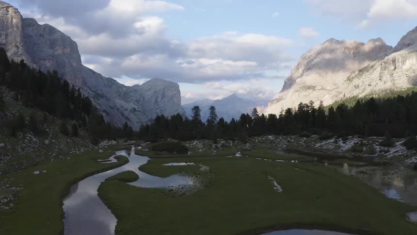 Aerial view of valley river with high mountains