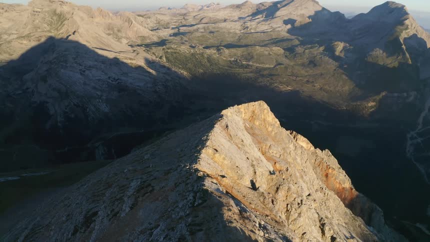 Mountain peaks cast a shadow on the valley of a range