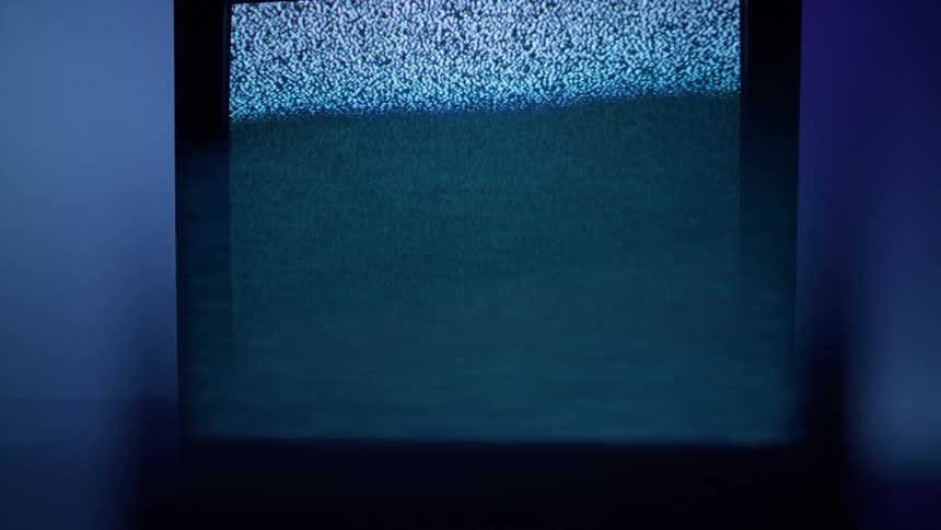 Television with fuzzy screen on purple background