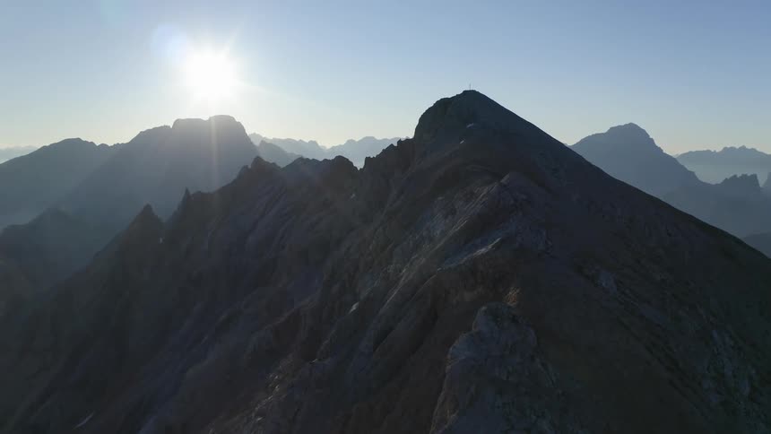 Aerial view of high mountains with sun shining bright