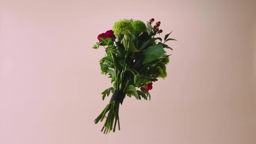 A bouquet of flowers floats and spins in air