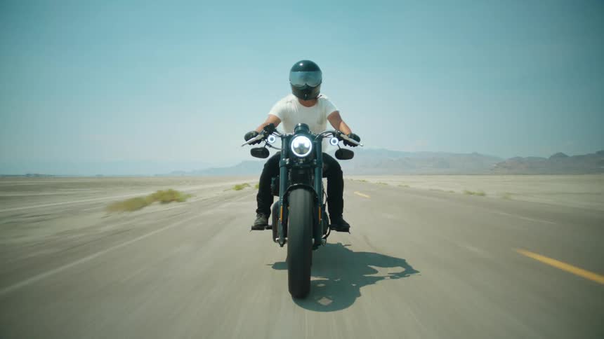 A man driving a motorbike on a rural road