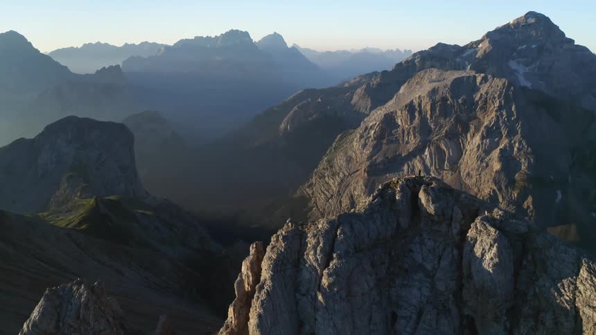 Mountains cast shadows on each other in a vast mountain range