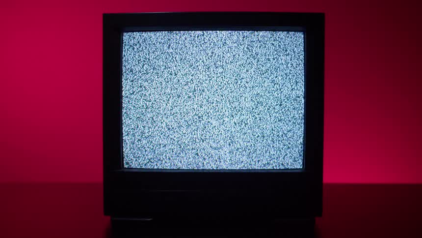 The television is flickering with white snow
