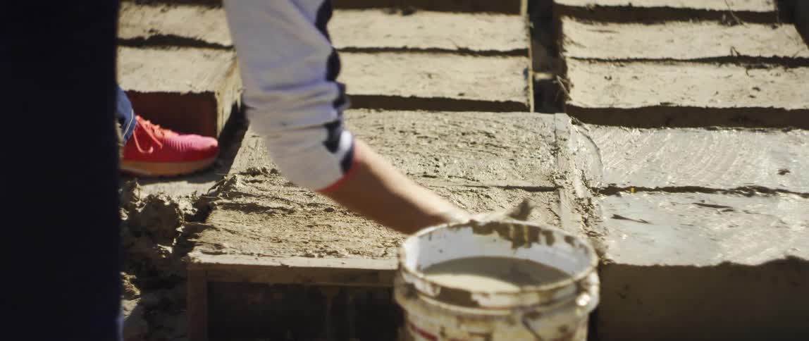 A construction worker working on some masonry