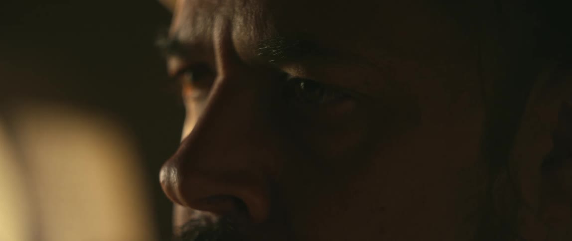 A man with furrowed brow stares straight ahead