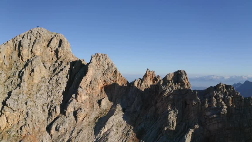 Tall mountains loom over a deep valley in the wilderness