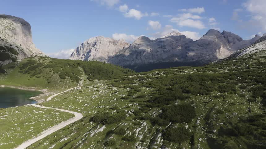 A small dirt trail runs through the hills