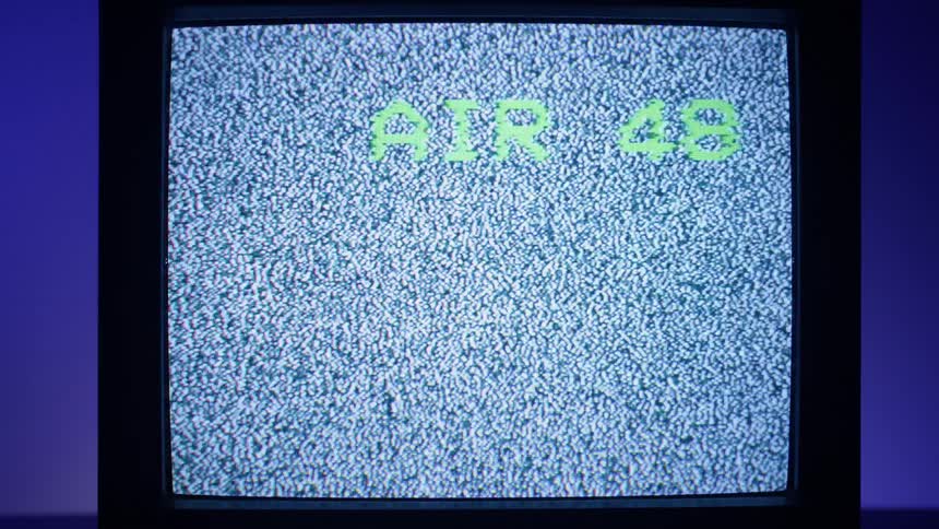 Numbers count down on a retro television showing static