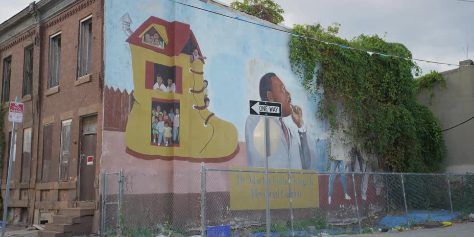 The side of a building has artwork on it