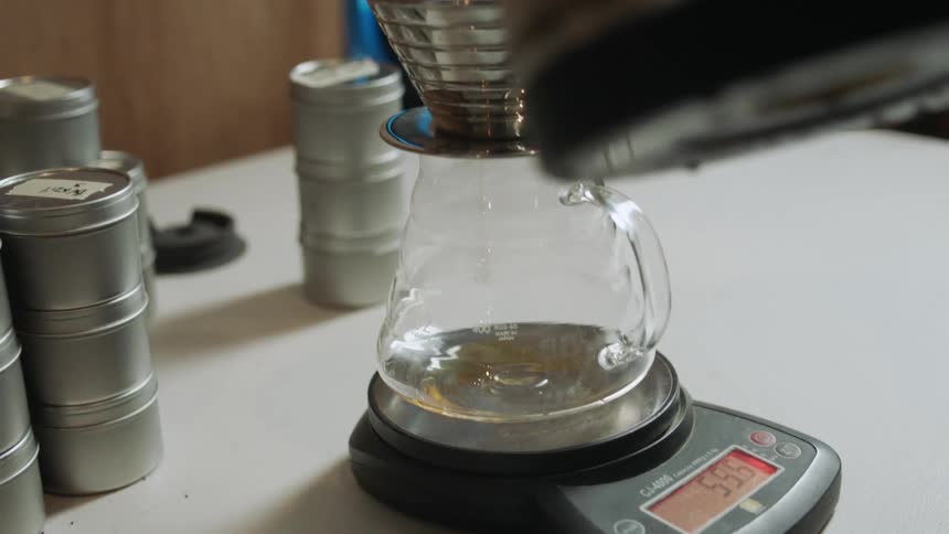 Water is pouring into a coffee pot