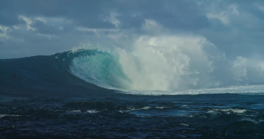 People are surfing on a big wave