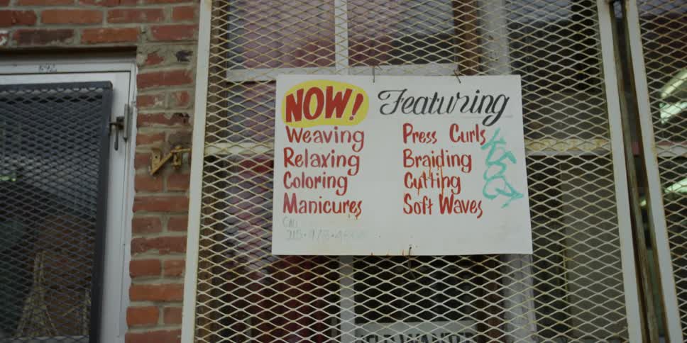A fenced window has a sign on it