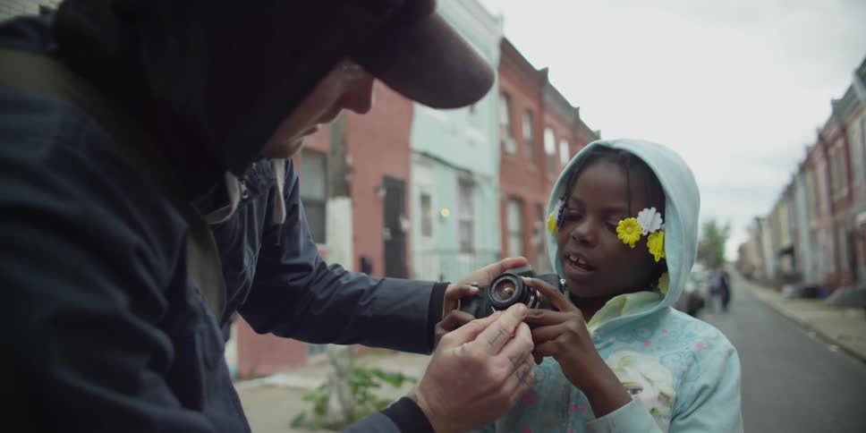 A man is showing a camera to a girl