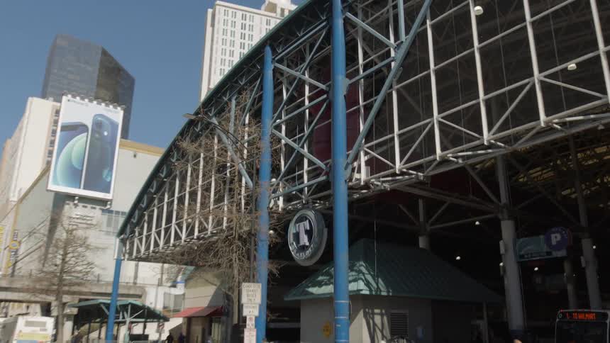 A man walks past a station in a large city
