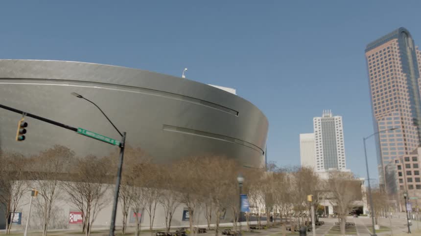Exterior view of city museum and high rise buildings against the blue sky