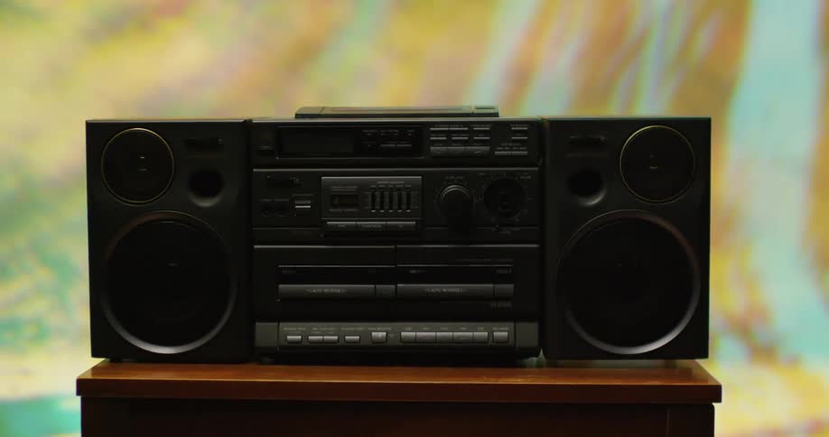 A boombox sitting on a table with colorful lights around it