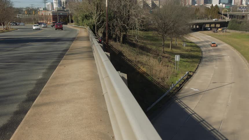Traffic moves along an overpass and on a freeway just outside a major city center
