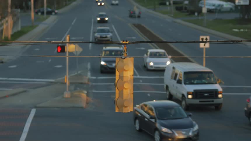 Multiple vehicles make a left turn on a roadway