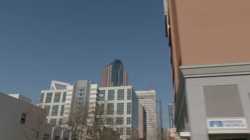 Tall buildingns on the skyline of the city downtown seen from the streets at daytime