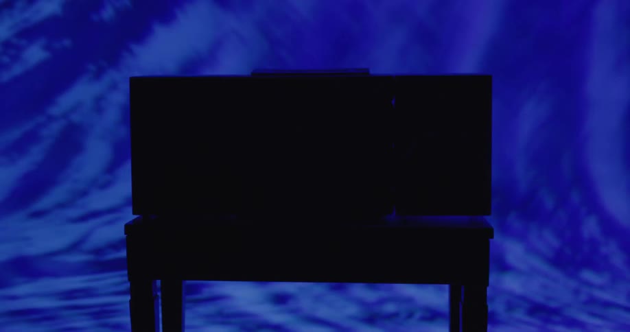A blue light flashes and creates shadows against a table