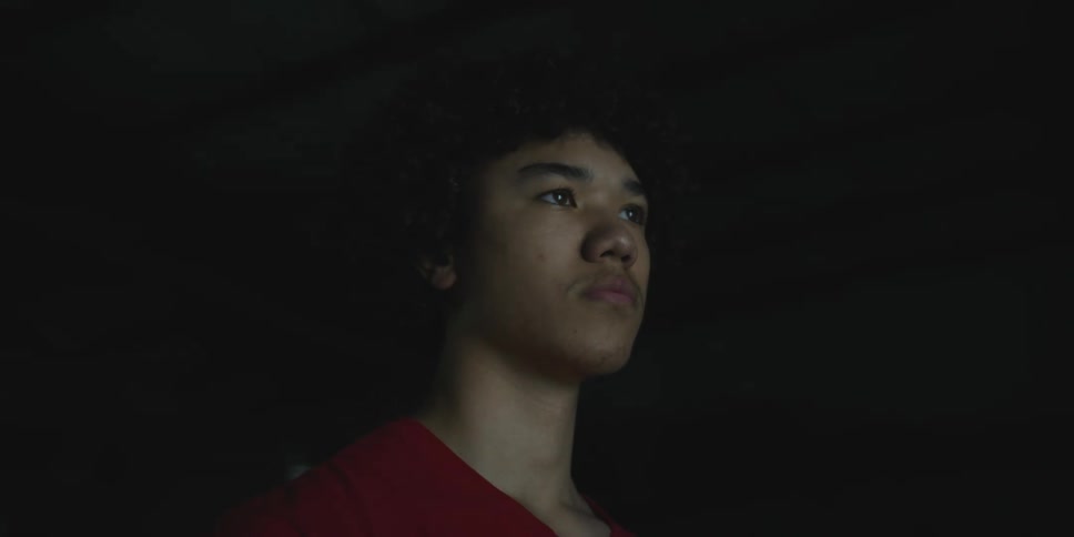A man standing in a dark room with a flashing light