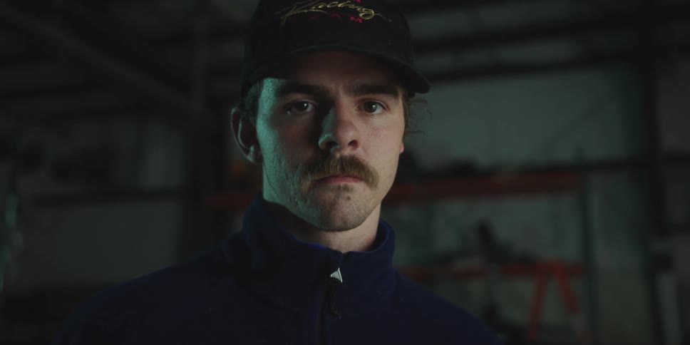 A portrait of a man standing in a room