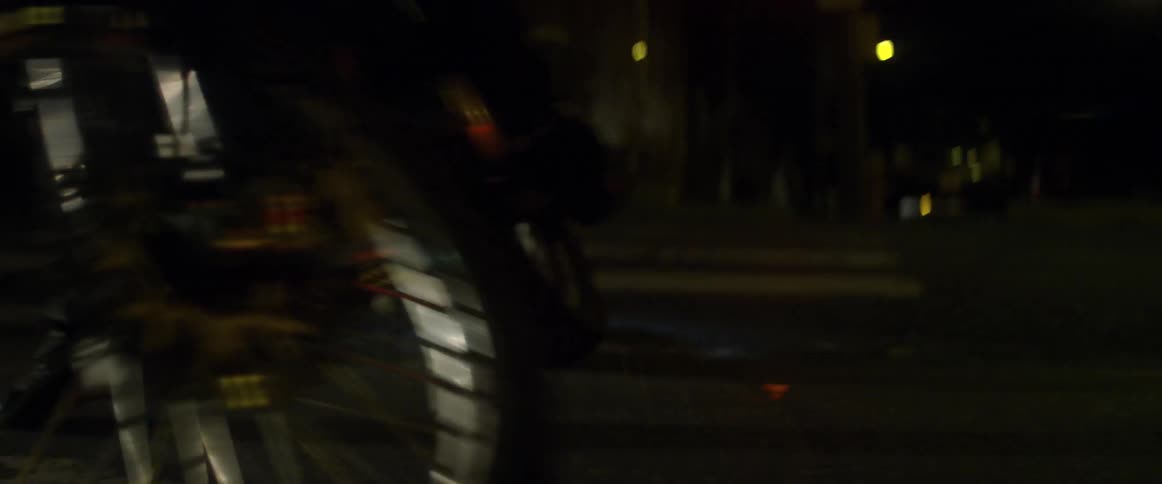 A person is doing doughnuts with his motorcycle at night