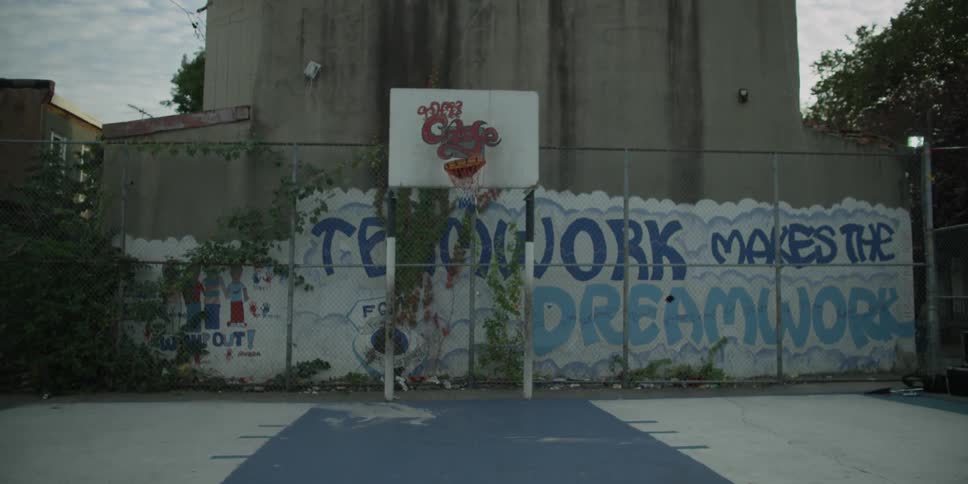 A basketball hoop near a painted wall