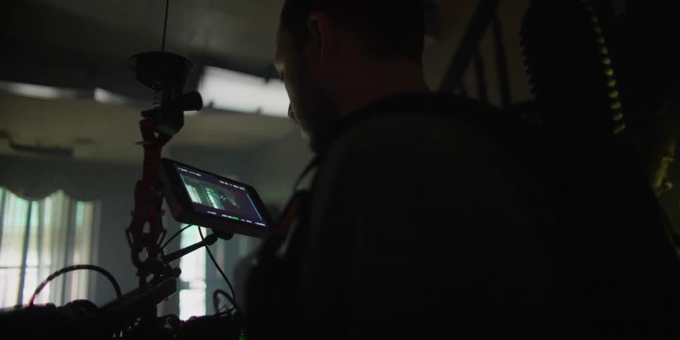 A man is filming in a home