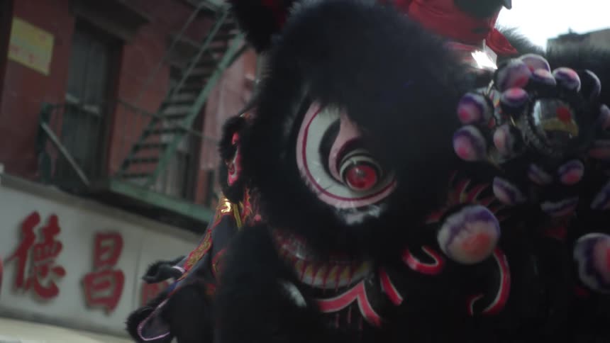 A view of a dragon in a parade outdoors