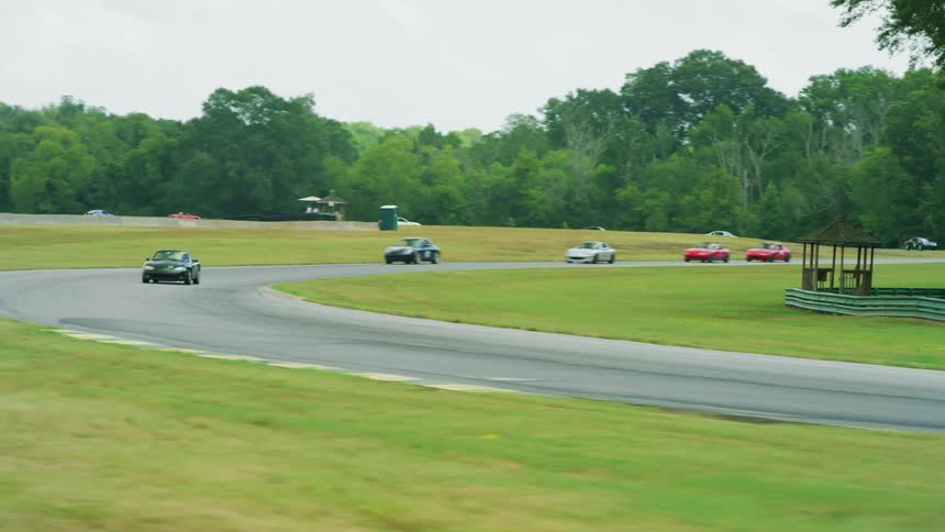 Cars racing around track