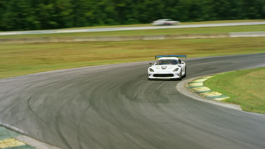 Cars racing around a race track