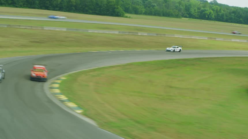 Aerial view of racing cars driving fast against each other