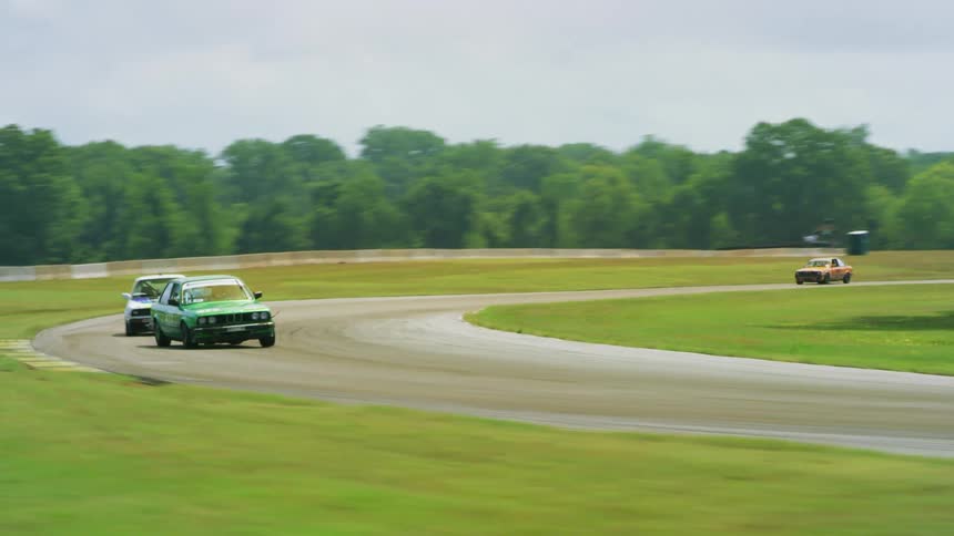 Race cars turn around the track