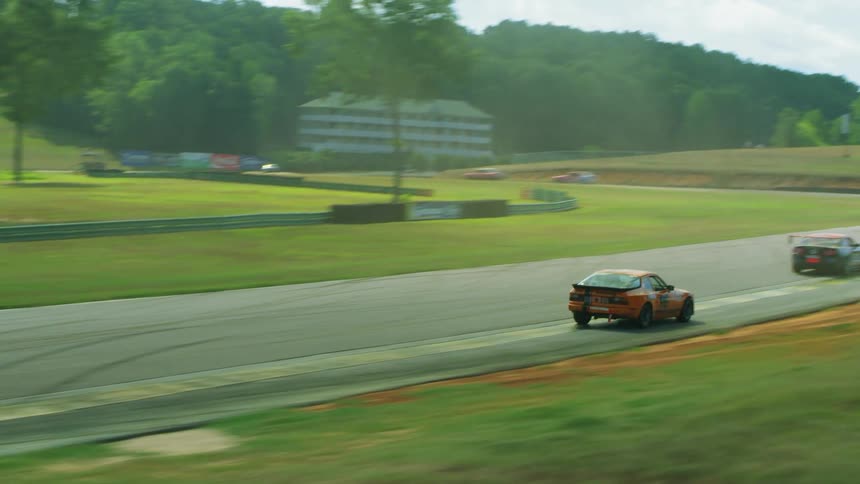Cars racing around a track outdoors