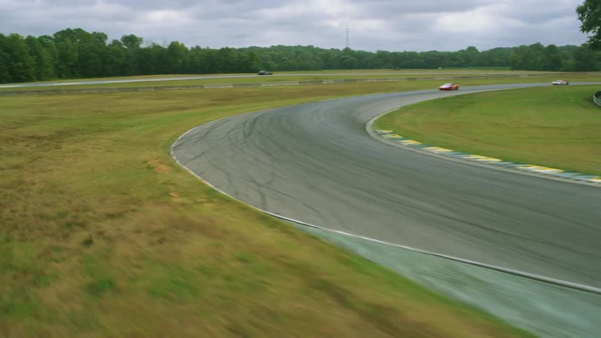 Race cars turn around the track together