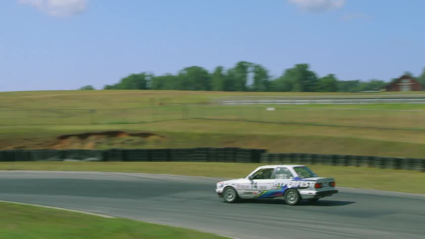 Aerial view of white car driving in motor car race