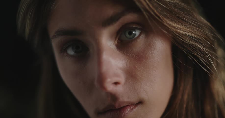 A portrait of a woman in a dark room