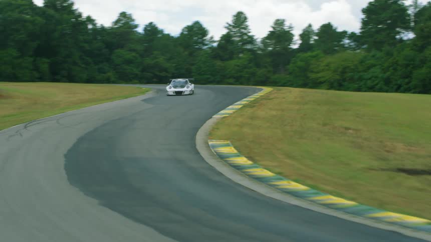 A person races a race car on a track
