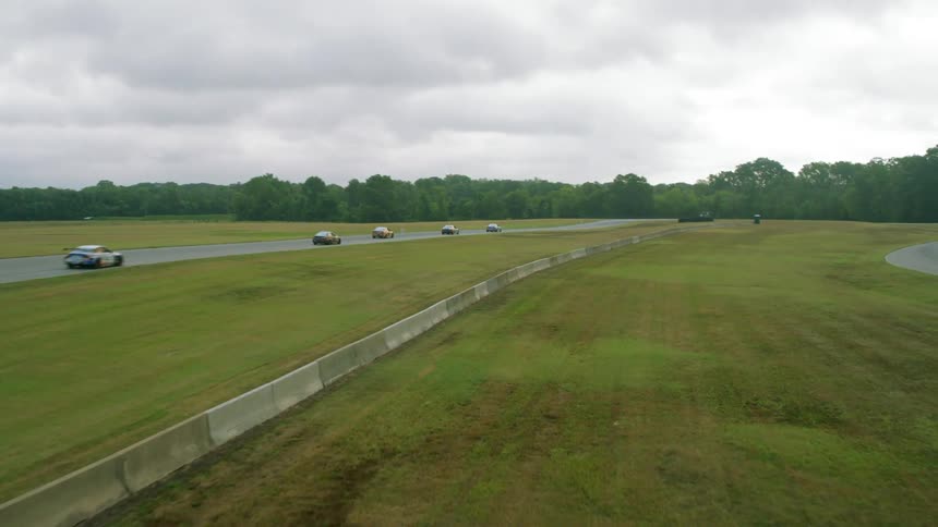 Race cars are driving down the runway