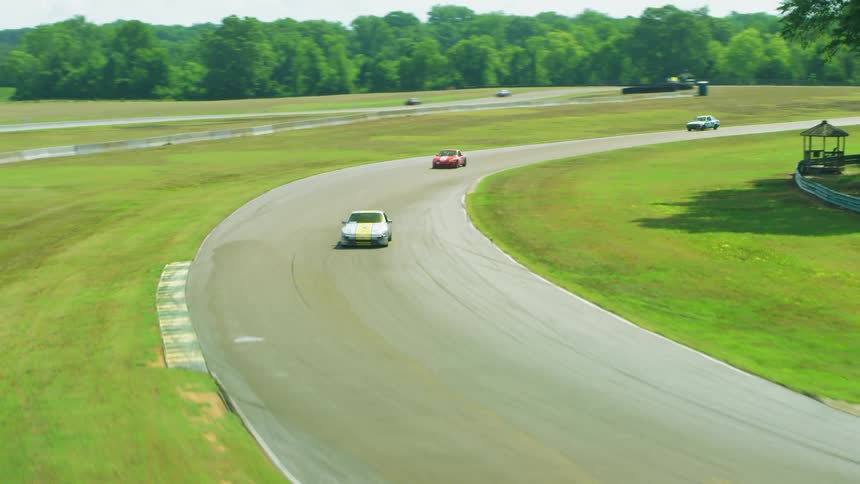 Aerial view of racing cars driving fast against each other