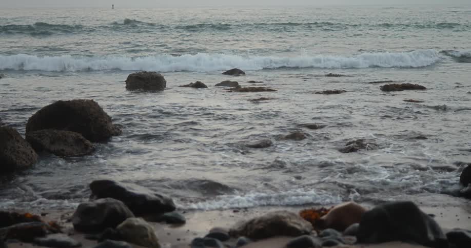 Small waves crash on the shore