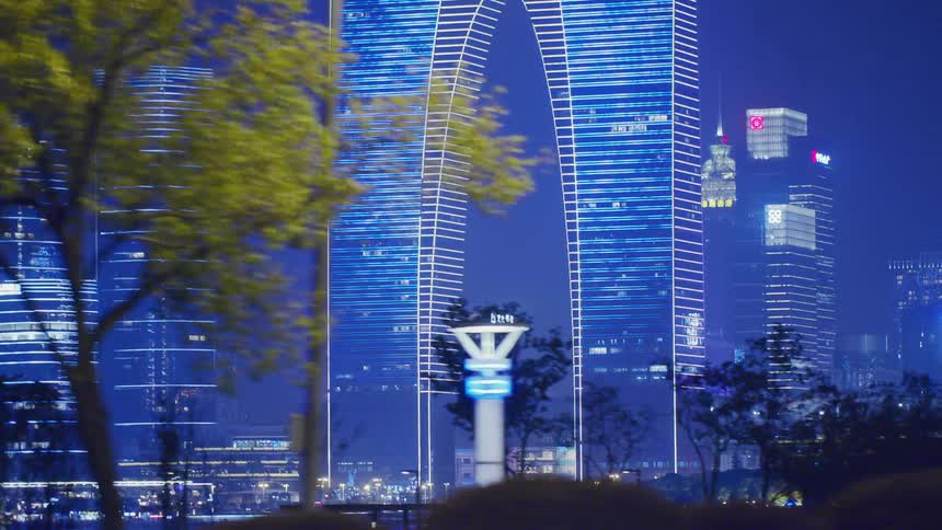 Brightly lit up buildings scatter throughout a large city