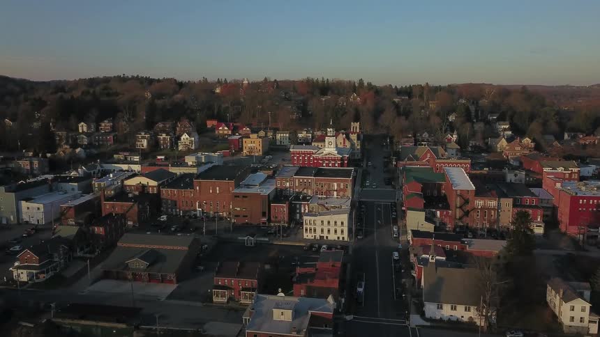 The camera flies above a lovely town with numerous brick buildings