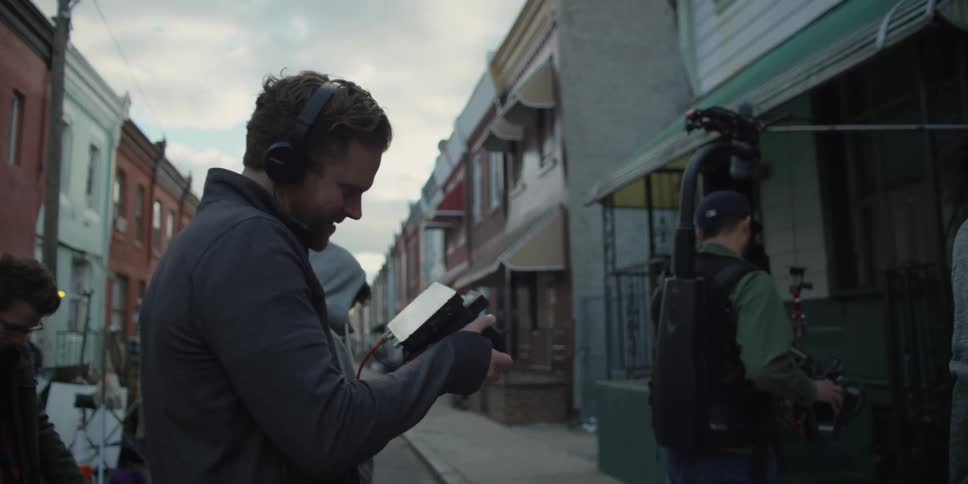 A film crew is recording on a street