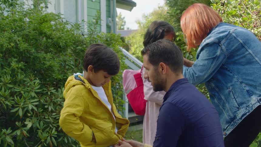 A family with parents getting their children ready for school