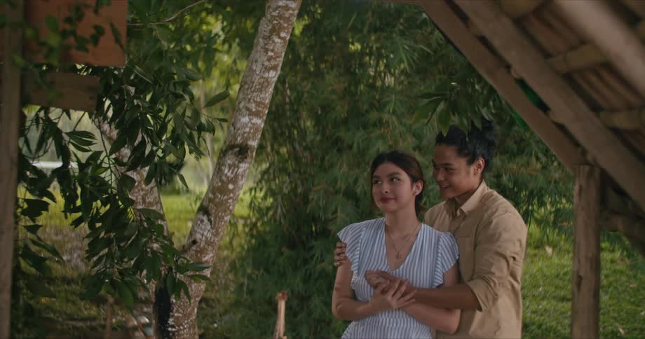 A boyfriend and girlfriend hugging outdoors